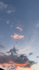 Sky transitions from day to sunset with crescent moon