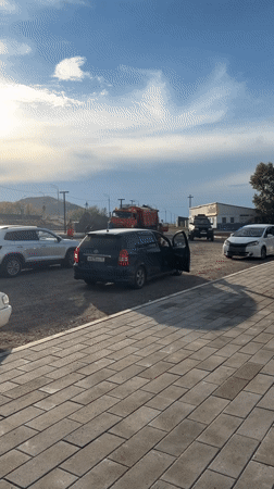 Airboat on trailer parked alongside vehicles in Turan