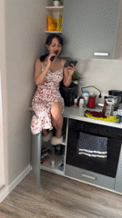 Woman performs kitchen counter karaoke session in Murino