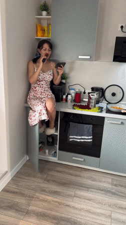 Woman performs kitchen counter karaoke session in Murino