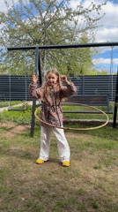 Girl plays with hula hoop in Russian backyard