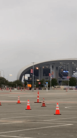 Parking lot outside SoFi Stadium on an overcast afternoon