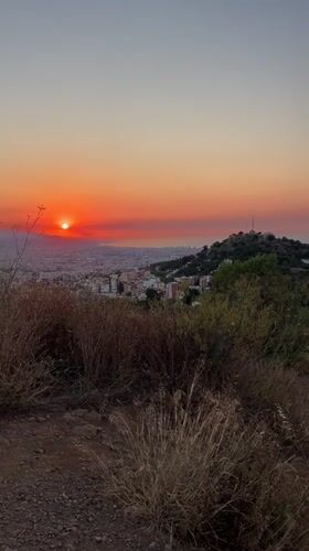 Sunset over Barcelona's skyline, shot from a hilltop