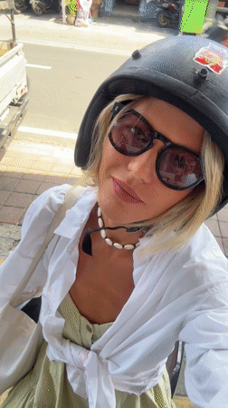 Woman Records Selfie Video on North Kuta Sidewalk