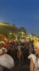 Carnival parade rolls through Barcelona streets at dusk