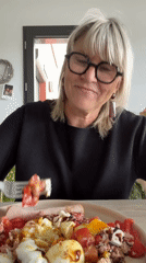 Woman enjoys homemade salad lunch with dog in Chambœuf