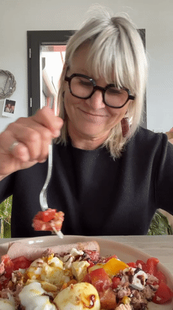 Woman enjoys homemade salad lunch with dog in Chambœuf