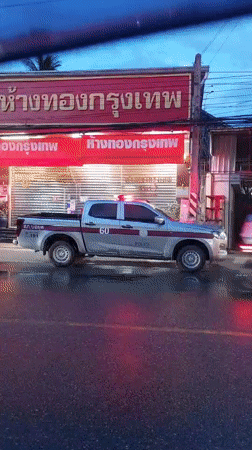 Koh Samui street scenes: police presence, rain, and local traffic