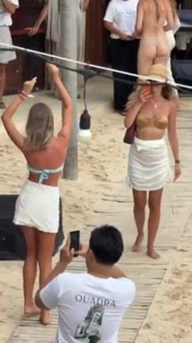 Beach club gathering in white attire, South Kuta