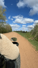 ATV rider travels dirt road in Можга, Russia