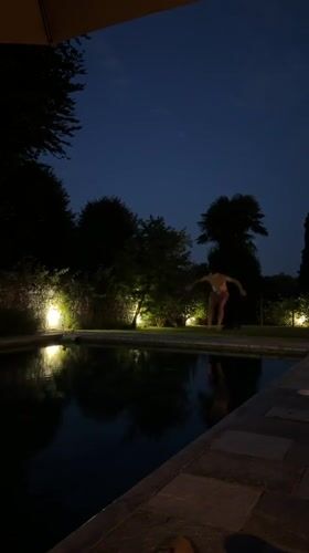 Nighttime pool jump at an illuminated outdoor pool in Angera
