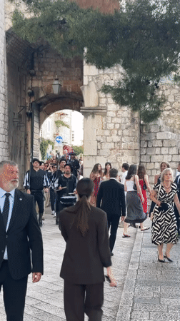 Traditional musicians perform on Dubrovnik's medieval walls for tourists