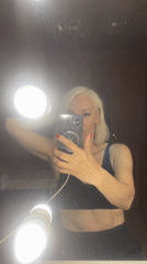 Mirror selfie under bright vanity lights in Saint Petersburg