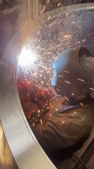 Welder works on metal structure in Montenegro workshop