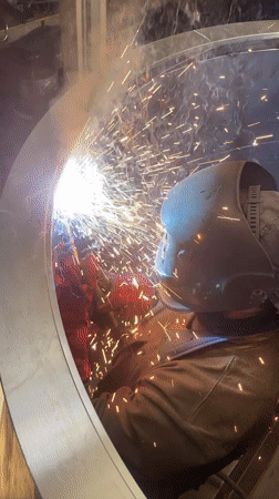 Welder works on metal structure in Montenegro workshop