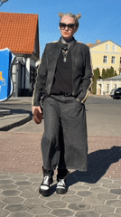 Woman walks through historic Hrodna past church to cafe