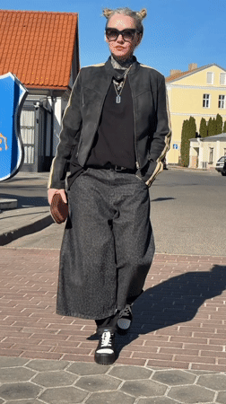 Woman walks through historic Hrodna past church to cafe