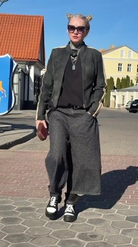 Woman walks through historic Hrodna past church to cafe