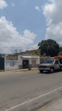 Tow trucks transport multiple off-road vehicles through Tinaquillo streets
