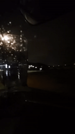 Night drive through rainy streets in Leudelange, Luxembourg