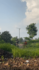 Children play around light pole outdoors