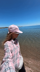 Woman visits Bosteri beach near amusement park in Kyrgyzstan