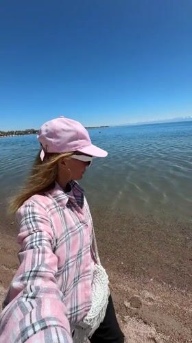Woman visits Bosteri beach near amusement park in Kyrgyzstan