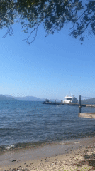 Quiet beach morning in Marmaris with a yacht offshore