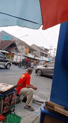 Street vendor scene outside a modern building in Purwodadi