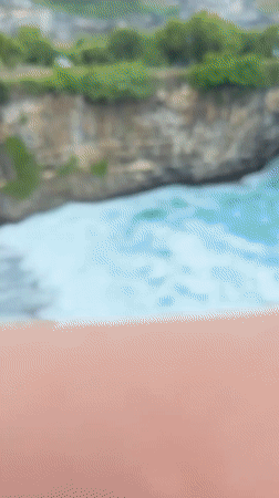 Tourists capture Nusa Penida's dramatic coastal rock formations