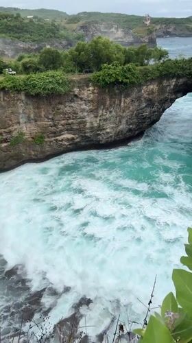 Tourists capture Nusa Penida's dramatic coastal rock formations