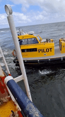 Yellow pilot boat spotted alongside larger vessel in Hamburg