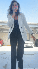 Woman smokes, poses in Dubai parking garage