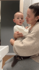 Woman holds toddler in casual moment, Odintsovo