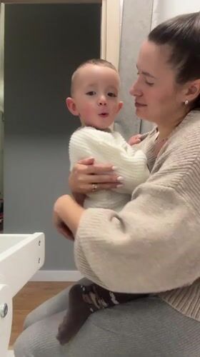 Woman holds toddler in casual moment, Odintsovo