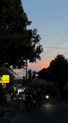 Evening motorcycle traffic observed in Denpasar during dusk