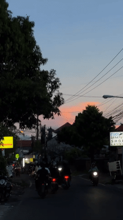 Evening motorcycle traffic observed in Denpasar during dusk