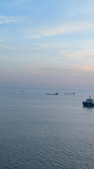 Offshore drilling rig and ships observed during Italian coast sunset