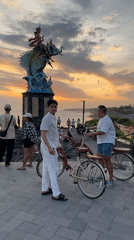 Tourists document sunset moments at Indonesian coastal attractions
