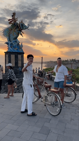 Tourists document sunset moments at Indonesian coastal attractions