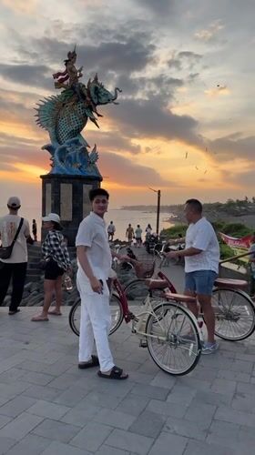 Tourists document sunset moments at Indonesian coastal attractions