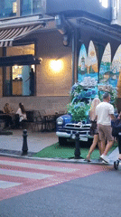 Decorated vintage Volga parked outside Batumi café amid contrasting architecture