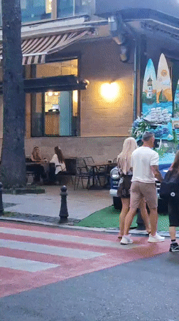 Decorated vintage Volga parked outside Batumi café amid contrasting architecture