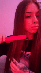 Young woman photographed under pink lighting in Buenos Aires