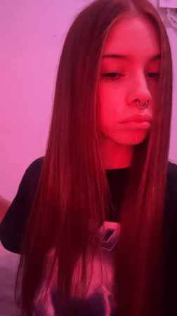 Young woman photographed under pink lighting in Buenos Aires
