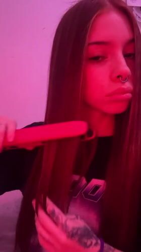 Young woman photographed under pink lighting in Buenos Aires