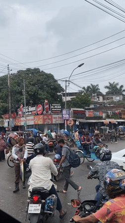 Rainy morning street life across Dhaka's busy commercial corridors