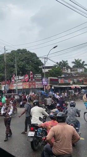 Rainy morning street life across Dhaka's busy commercial corridors