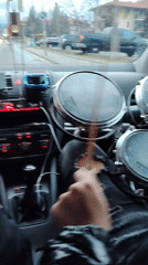 Passenger carries drum set in car through Bansko streets