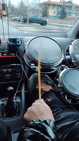 Passenger carries drum set in car through Bansko streets